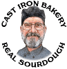The face of an older man with a grey beard, glasses and a black hat is in a white square frame with the black text 