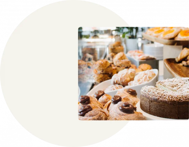 A white circle is displayed on a grey background with a cakes and pastries displayed in a square on the right-hand side of the background.
