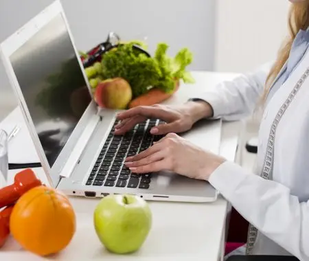 nutritionist typing on her laptop
