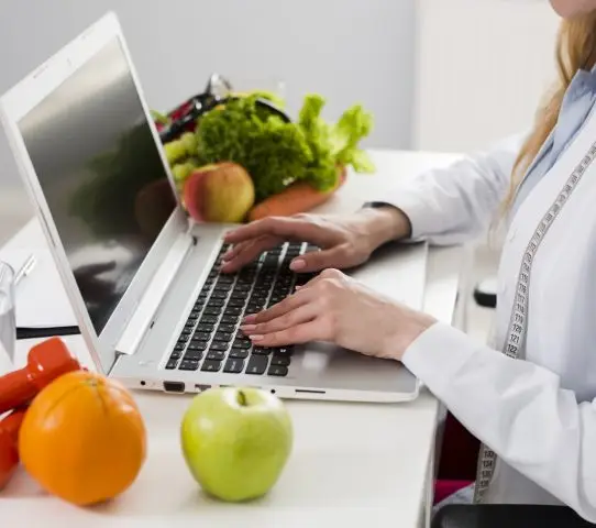 nutritionist typing on her laptop
