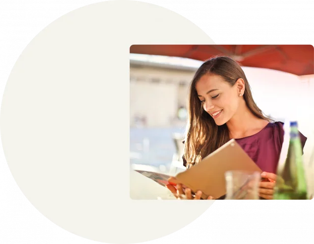 A square depicts a woman looking through a menu. Behind and to the left of the image is a grey square with a white circle in the center.