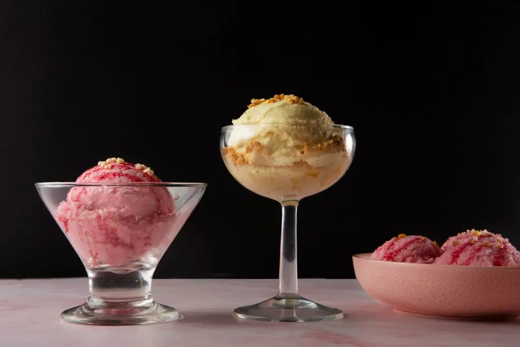 Strawberry and vanilla frozen desserts served in glasses, showing different ice cream and sorbet styles