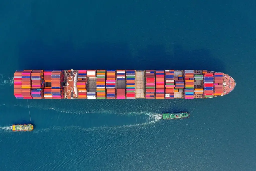 Aerial view of container cargo ship in sea, representing exporting food products across different regions.